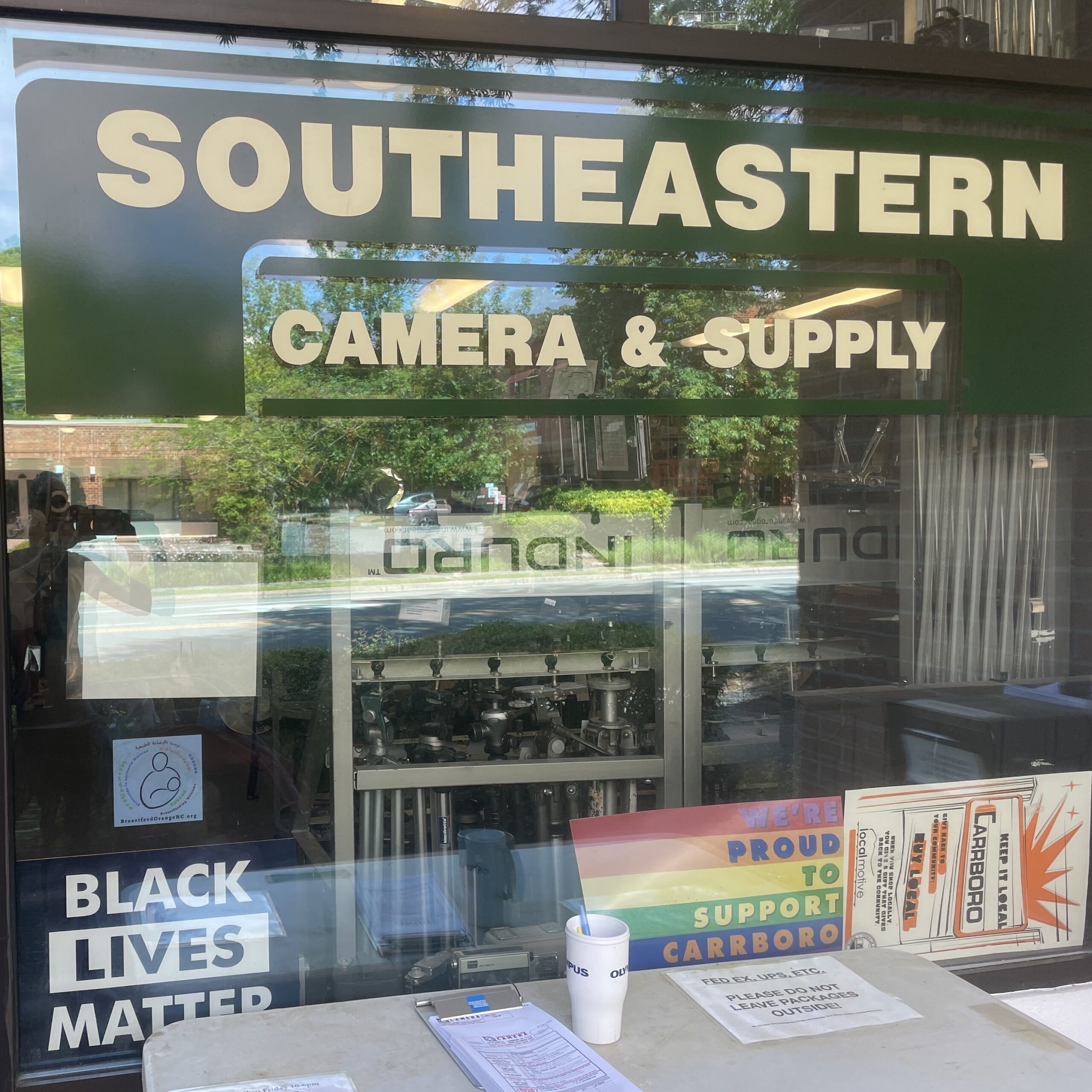 Southeastern Camera & Supply window with Breastfeed Orange NC cling and others