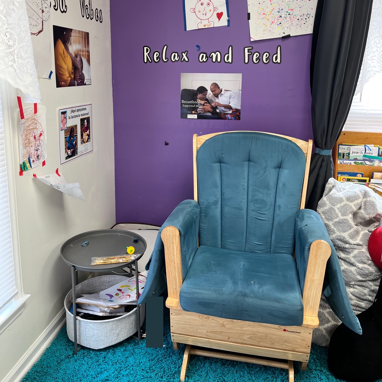 Image of lactation space with rocking chair, small table, and pictures on the wall