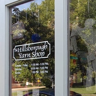 Front window of The Hillsborough Yarn Shop with text: The Hillsborough Yarn Shop