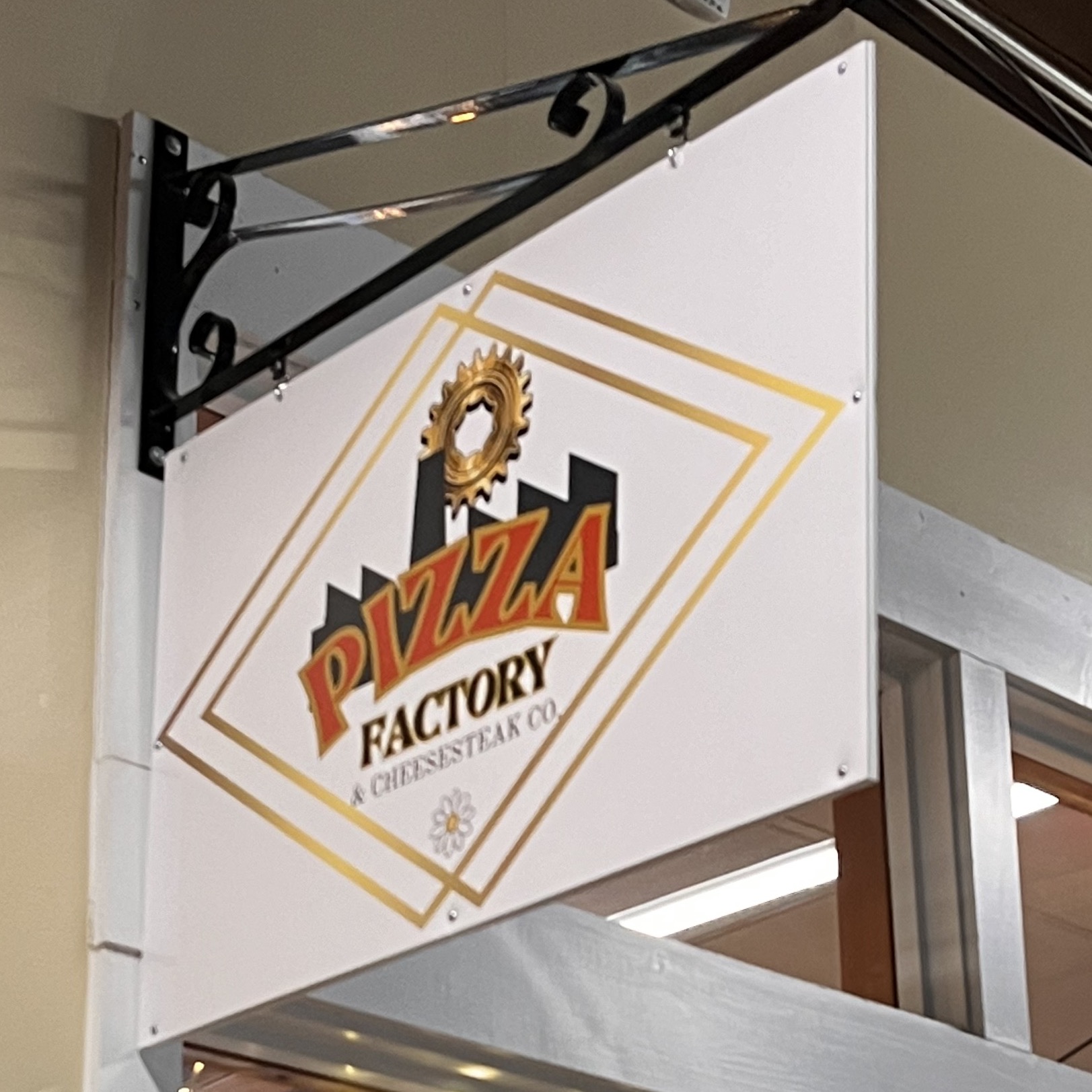 Pizza factory sign above door