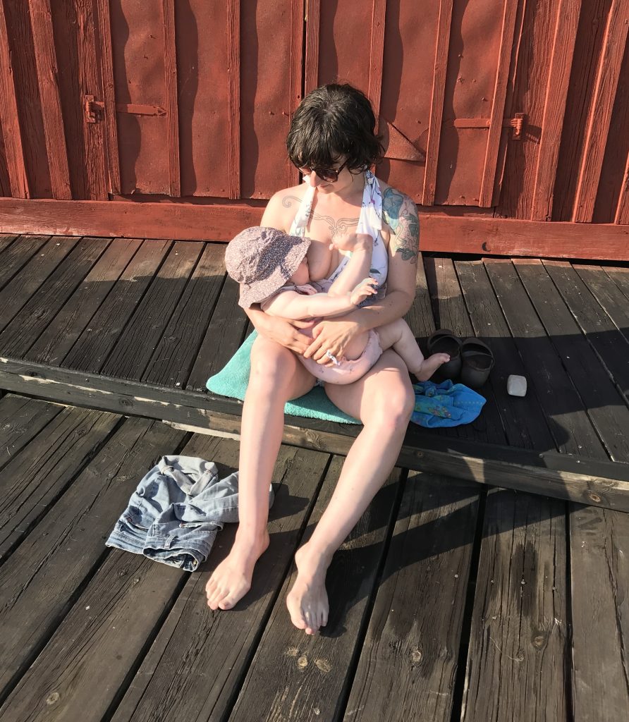 Infant nursing at the pool
