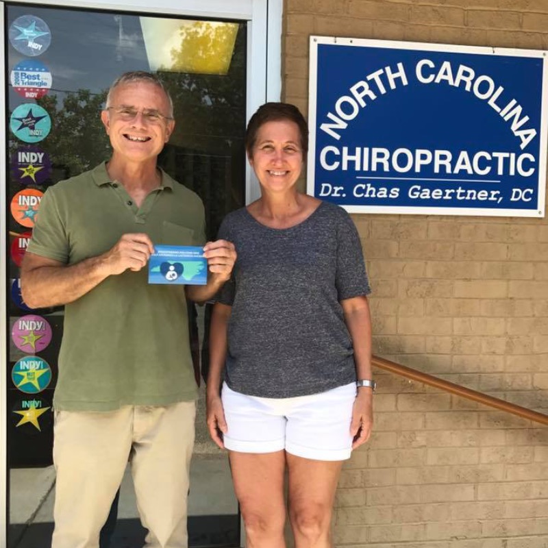 NC Chiropractic office front door with two employees standing in front of door