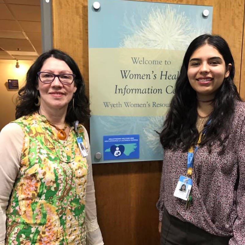 Two UNC Hospital Women's Center employees standing in front of the door to the center