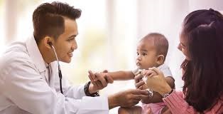 physician looking at infant